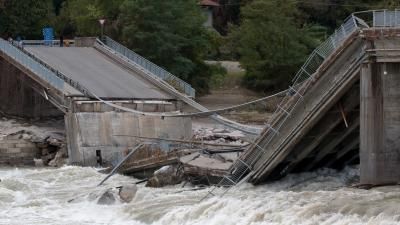 Collapsed bridge on flowing river