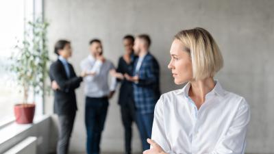 Woman being excluded from conversation from group of four men
