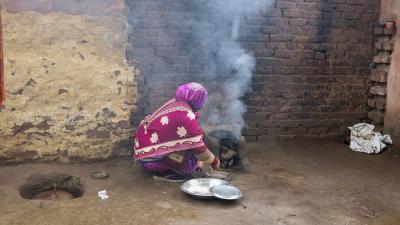 A woman in India cooking food.