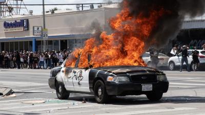 A photograph of a burning police car, taken in Los Angeles, United States during a protest against police violence over the death of George Floyd.