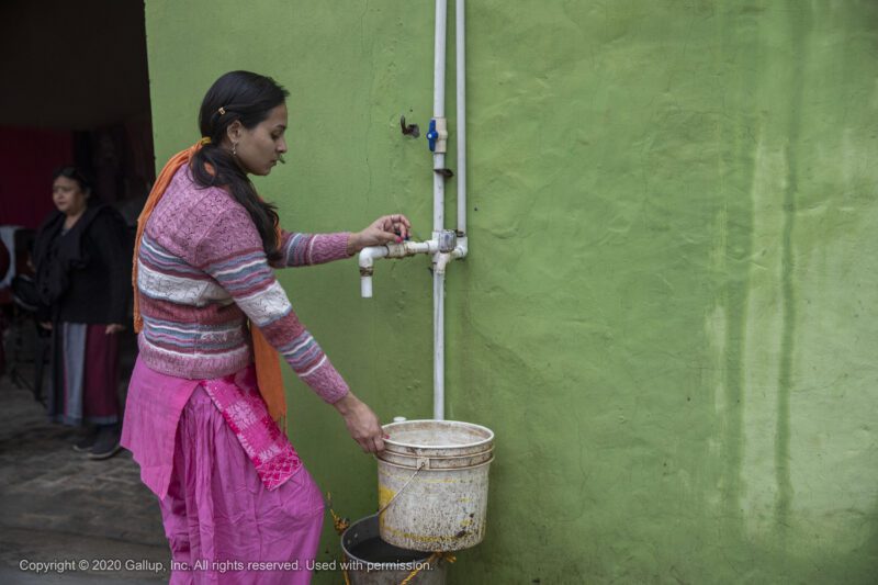 Woman in India filling water container