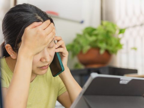 Female worker worried on phone